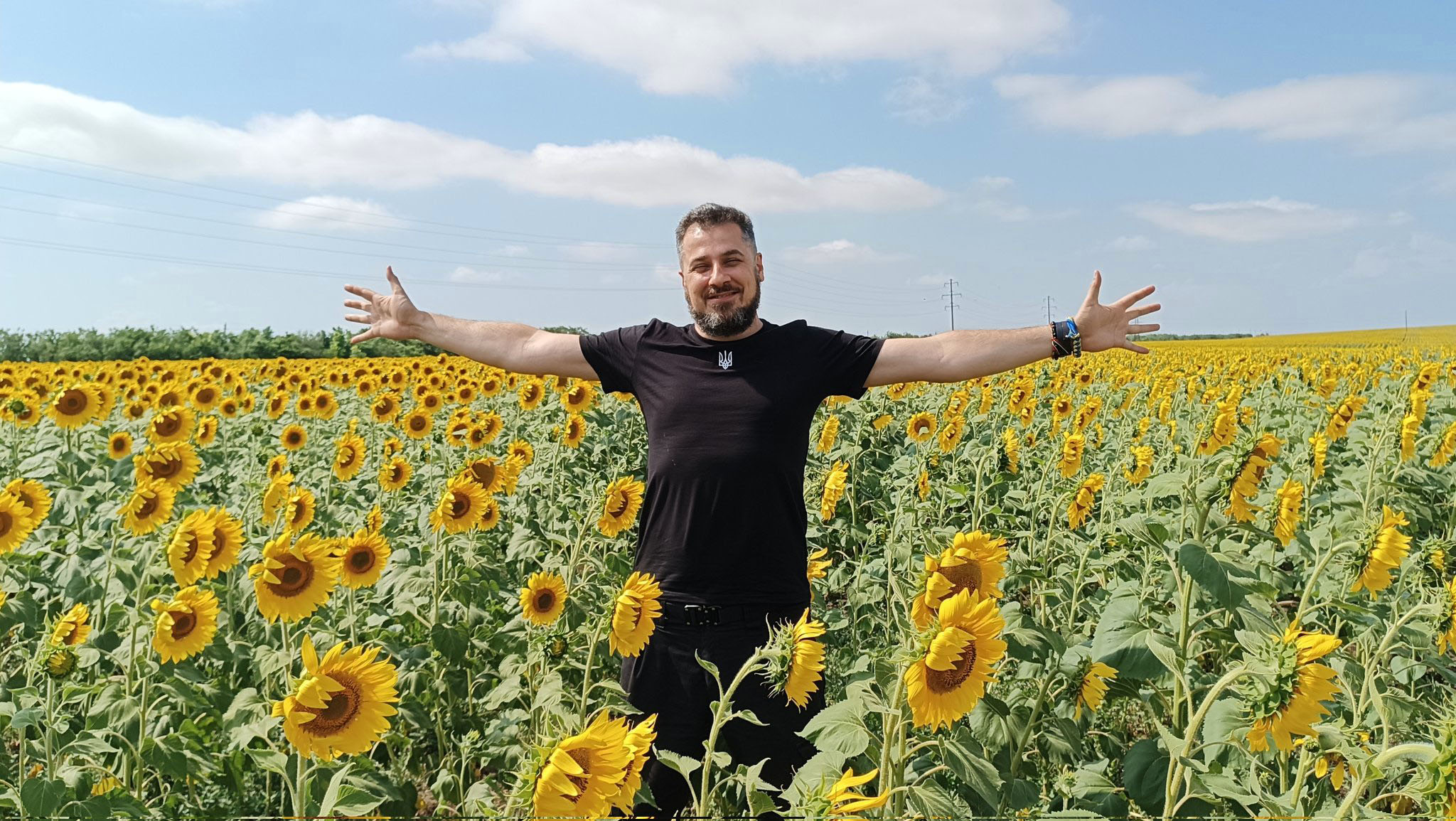 Oleg Veretskiy in an open field of sunflowers